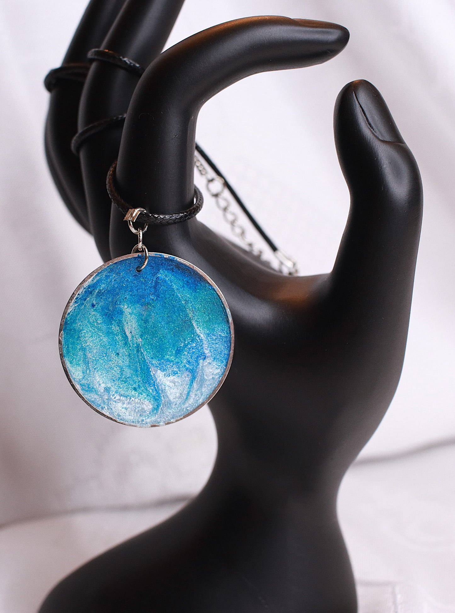 Round azure necklace hanged on a black cord